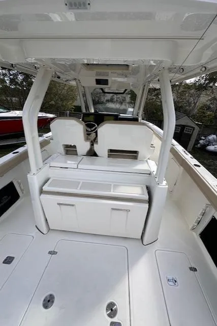 Slide: The Image of 2019 Pursuit S 328 Sport boat interior, featuring dual seats and a spacious deck. - 10