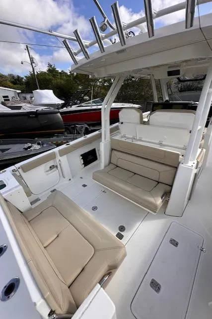 Slide: The Image of 2019 Pursuit S 328 Sport boat interior with beige seating and rod holders. - 11