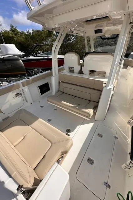 Slide: The Image of 2019 Pursuit S 328 Sport boat interior with beige seating and modern design. - 12