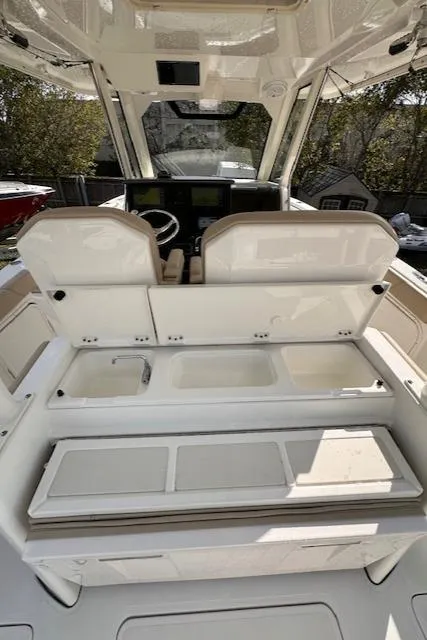Slide: The Image of 2019 Pursuit S 328 Sport boat interior with seating and helm station. - 13