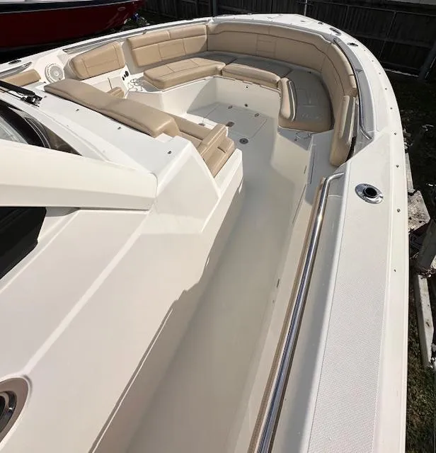 Slide: The Image of 2019 Pursuit S 328 Sport boat interior with beige seating and spacious deck. - 5