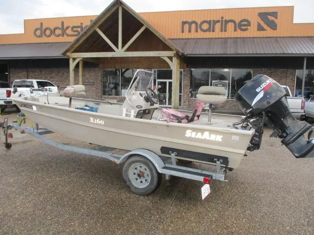 Slide: The Image of 2008 SeaArk X160 CC boat on trailer outside marine store. - 1