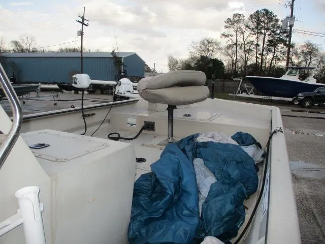 Slide: The Image of 2008 SeaArk X160 CC boat interior with seat and equipment, parked outdoors. - 4