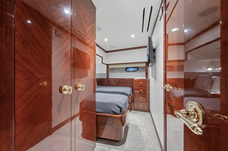 Slide: The Image of Luxurious 2006 Cheoy Lee motor yacht bedroom with elegant wood finishes and modern amenities. - 10