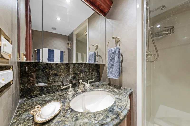 Slide: The Image of Luxurious bathroom in 2006 Cheoy Lee Motor Yacht with marble countertop and modern shower. - 12