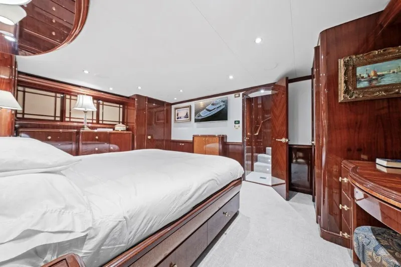 Slide: The Image of Luxurious 2006 Cheoy Lee motor yacht bedroom with elegant wood paneling and plush bedding. - 14