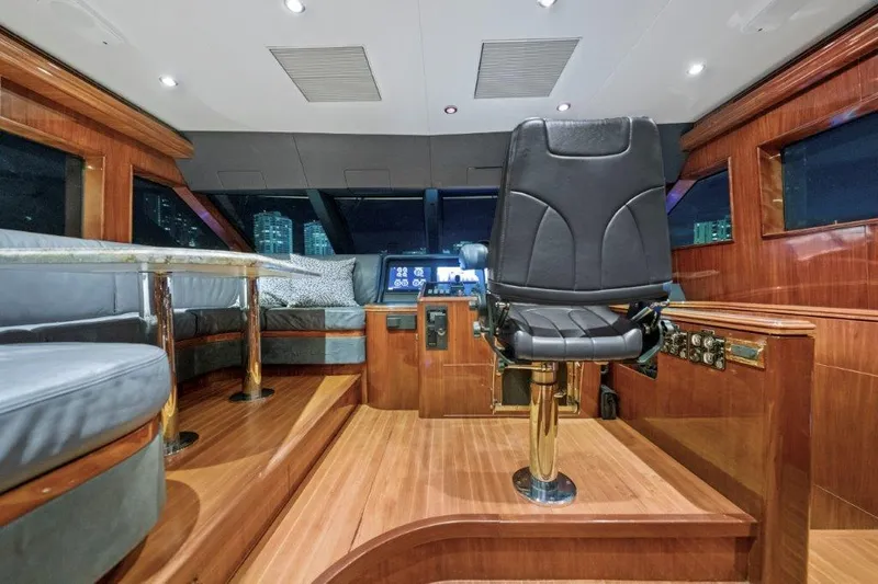 Slide: The Image of Luxurious 2006 Cheoy Lee motor yacht interior with captain's chair and wood paneling. - 19