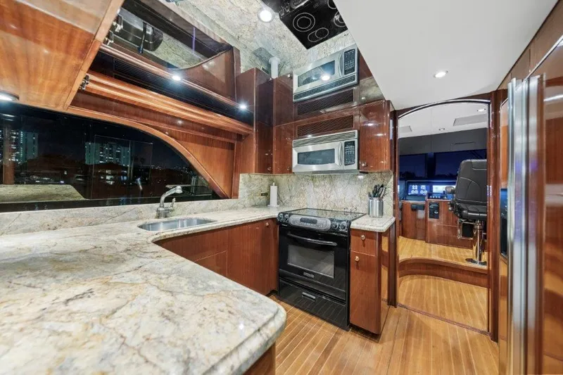 Slide: The Image of Luxurious 2006 Cheoy Lee Motor Yacht kitchen with modern appliances and elegant wood finishes. - 2