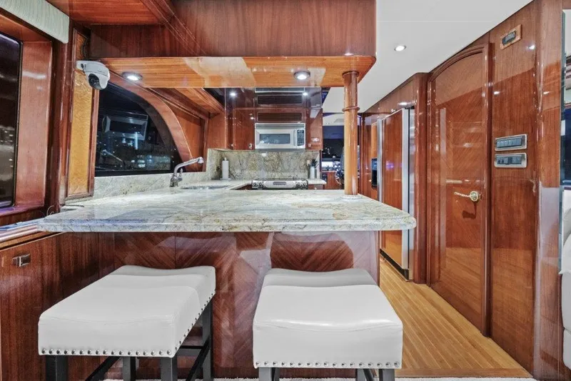 Slide: The Image of Luxurious 2006 Cheoy Lee Motor Yacht interior with elegant wood finishes and modern kitchen amenities. - 23