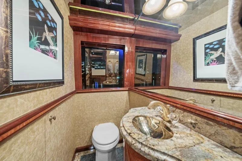 Slide: The Image of Luxurious bathroom in 2006 Cheoy Lee Motor Yacht with elegant fixtures and framed artwork. - 29
