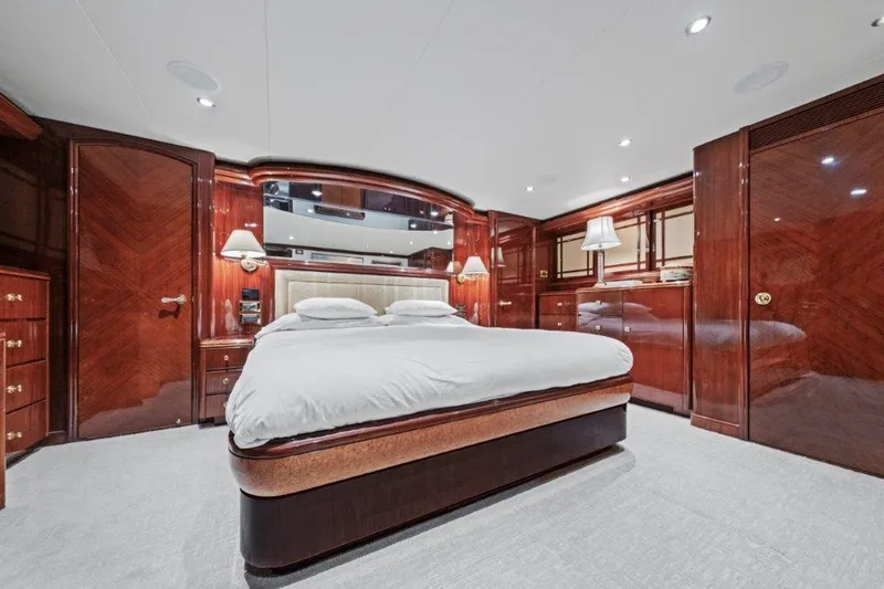 Slide: The Image of Luxurious 2006 Cheoy Lee motor yacht bedroom with elegant wood paneling and modern lighting. - 3