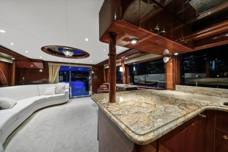 Slide: The Image of Luxurious 2006 Cheoy Lee Motor Yacht interior with elegant wood finishes and spacious seating area. - 30