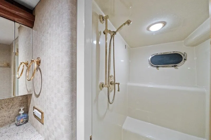 Slide: The Image of Luxurious bathroom in 2006 Cheoy Lee Motor Yacht with shower and porthole window. - 34