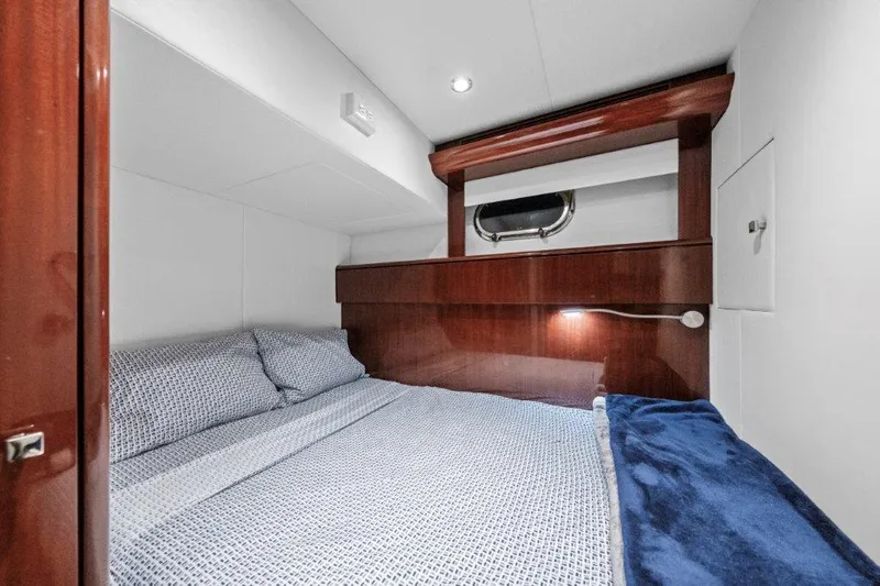 Slide: The Image of Luxurious cabin interior of 2006 Cheoy Lee Motor Yacht with cozy bedding and elegant wood finish. - 35