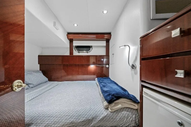 Slide: The Image of Luxurious 2006 Cheoy Lee Motor Yacht bedroom with elegant wood finishes and cozy bedding. - 36