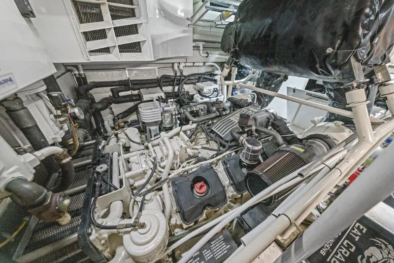 Slide: The Image of Engine room of a 2006 Cheoy Lee Motor Yacht, showcasing complex machinery and components. - 38