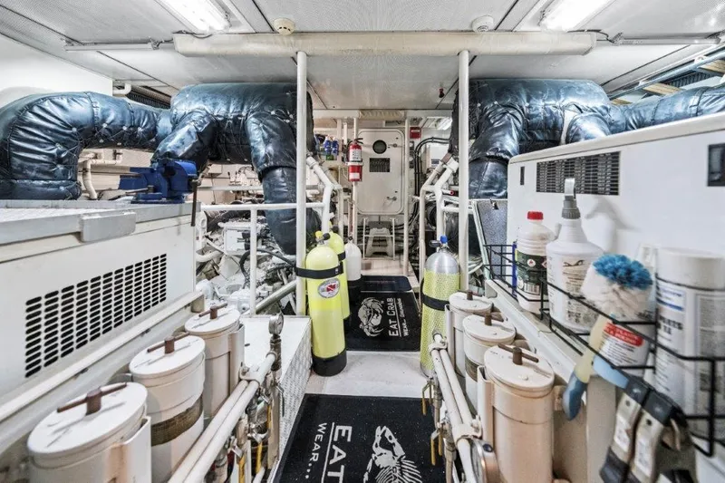 Slide: The Image of Engine room of a 2006 Cheoy Lee Motor Yacht, featuring equipment and storage. - 39