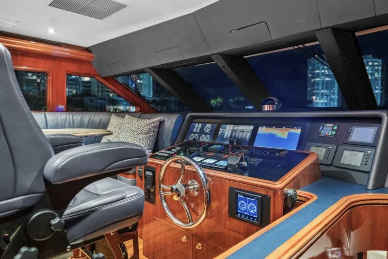 Slide: The Image of Luxurious 2006 Cheoy Lee motor yacht helm with modern navigation equipment and plush seating. - 4