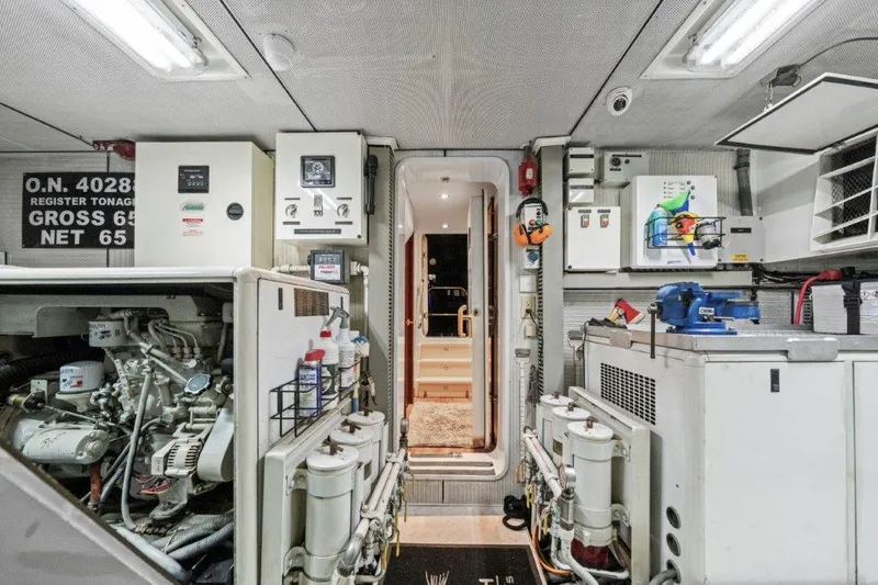 Slide: The Image of Engine room of a 2006 Cheoy Lee Motor Yacht, featuring machinery and control panels. - 40