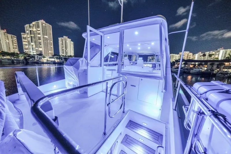 Slide: The Image of Luxurious 2006 Cheoy Lee Motor Yacht illuminated at night, city skyline in background. - 46