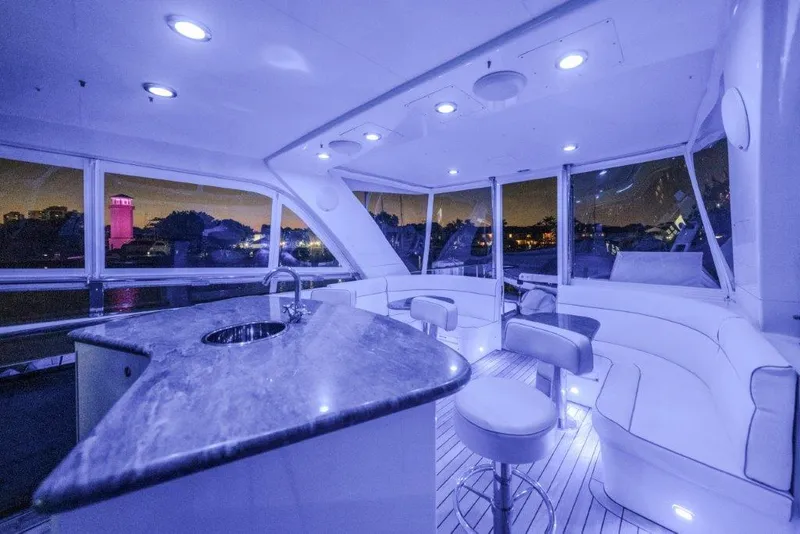 Slide: The Image of Luxurious 2006 Cheoy Lee Motor Yacht interior with modern seating and ambient lighting at night. - 48
