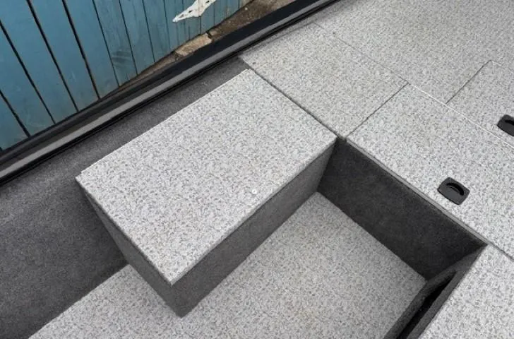 Slide: The Image of 2024 Tracker Pro 170 boat interior with gray carpeted flooring and storage compartments. - 14