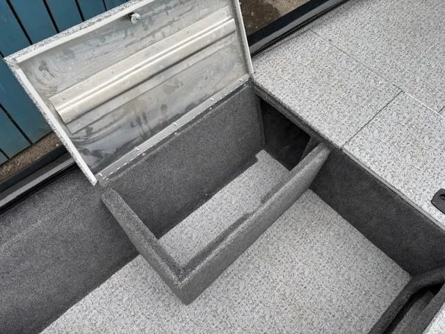 Slide: The Image of 2024 Tracker Pro 170 boat storage compartment with open lid, showcasing interior space. - 15