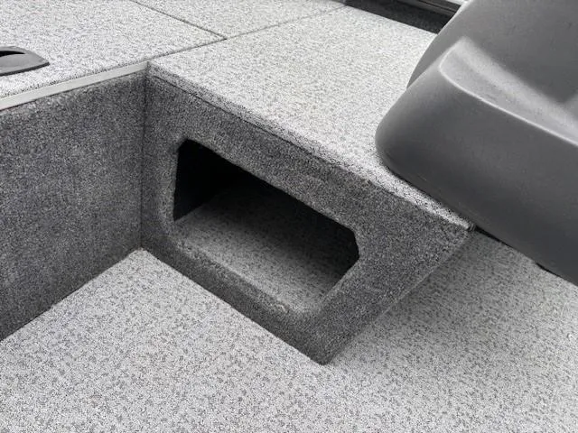 Slide: The Image of 2024 Tracker Pro 170 boat interior with carpeted storage compartment. - 16