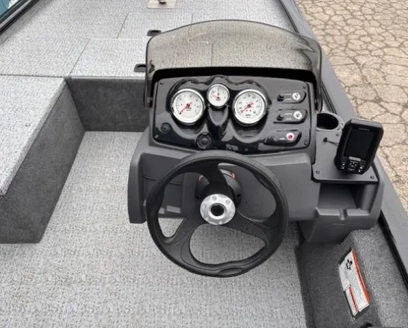 Slide: The Image of 2024 Tracker Pro 170 boat dashboard with steering wheel and gauges. - 18