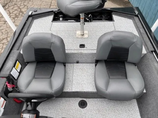 Slide: The Image of 2024 Tracker Pro 170 boat interior with two gray seats and carpeted flooring. - 19