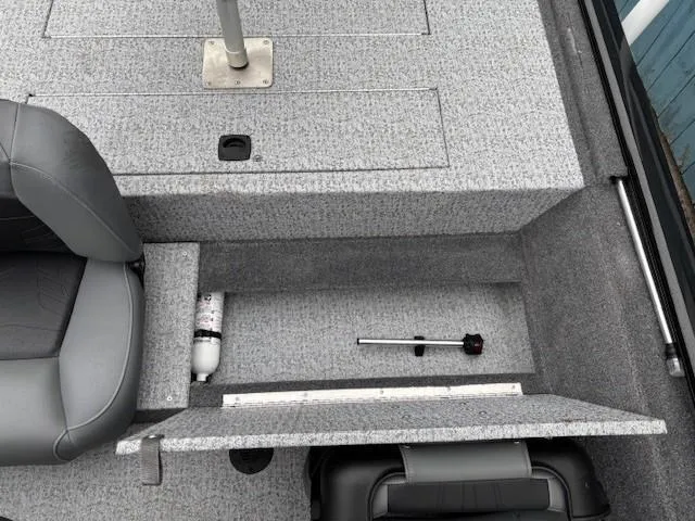 Slide: The Image of 2024 Tracker Pro 170 boat interior storage compartment with seat and equipment. - 21