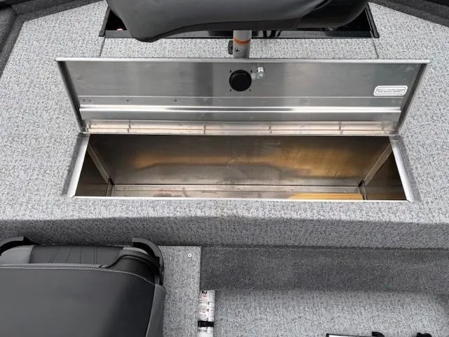 Slide: The Image of 2024 Tracker Pro 170 boat storage compartment with gray carpeted interior. - 22