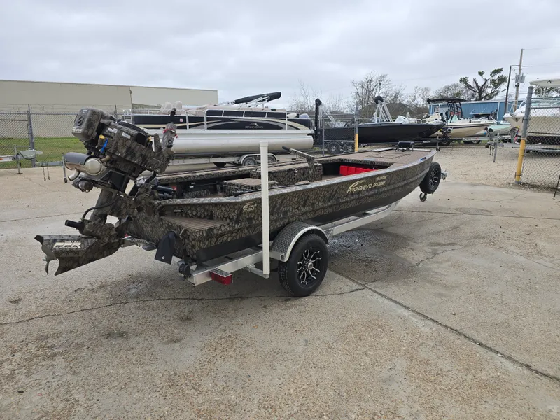 Slide: The Image of 2025 Pro-Drive 1854 boat on trailer, camo design, parked outdoors. - 4