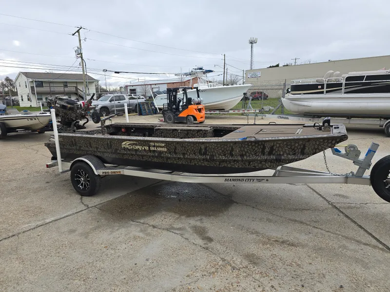 Slide: The Image of 2025 Pro-Drive 1854 boat on trailer in outdoor dealership setting. - 5