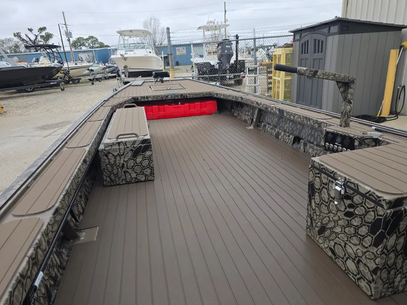 Slide: The Image of 2025 Pro-Drive 1854 boat with camo design, spacious deck, and storage compartments. - 8