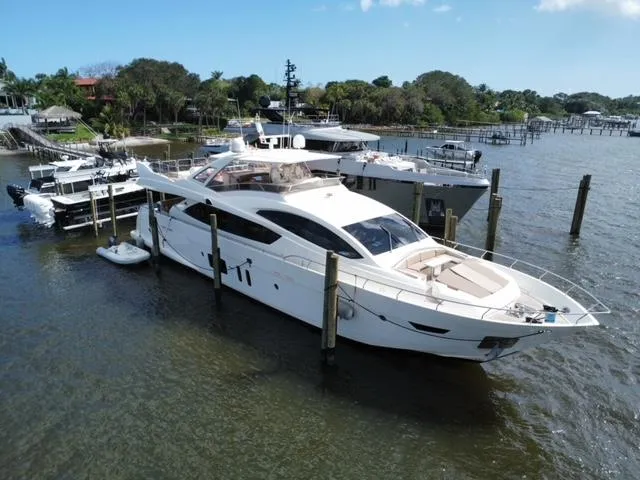 Slide: The Image of Astondoa 96 GLX 2009 yacht docked in a marina, surrounded by water and other boats. - 12