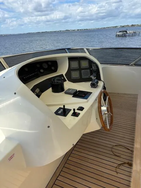 Slide: The Image of Control deck of 2009 Astondoa 96 GLX yacht with wooden steering wheel and navigation instruments. - 15