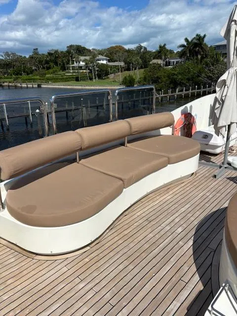 Slide: The Image of Astondoa 96 GLX 2009 yacht deck with beige seating, wooden flooring, and waterfront view. - 19