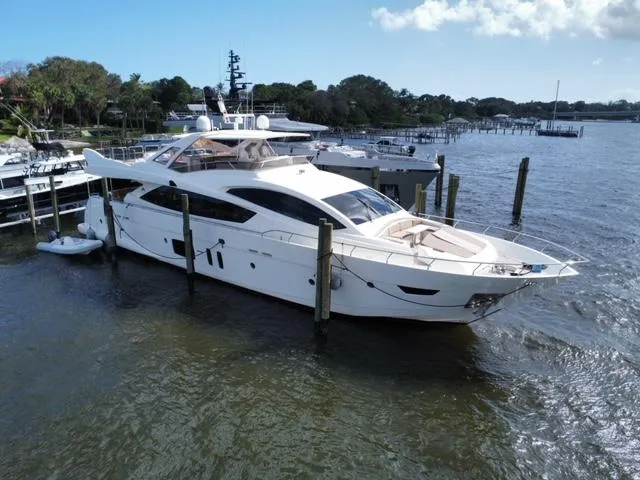 Slide: The Image of Astondoa 96 GLX 2009 yacht docked at marina, surrounded by calm waters and trees. - 2