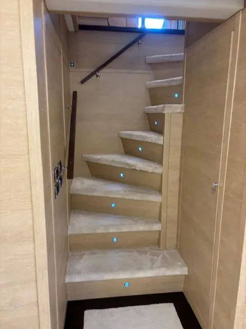 Slide: The Image of Staircase inside 2009 Astondoa 96 GLX yacht with modern lighting and wooden finish. - 28