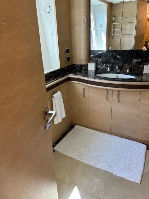 Slide: The Image of Luxurious bathroom in 2009 Astondoa 96 GLX yacht with modern fixtures and wood cabinetry. - 29