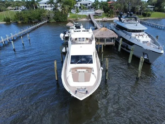 Slide: The Image of Astondoa 96 GLX yacht, 2009 model, docked at a marina with surrounding water and greenery. - 4