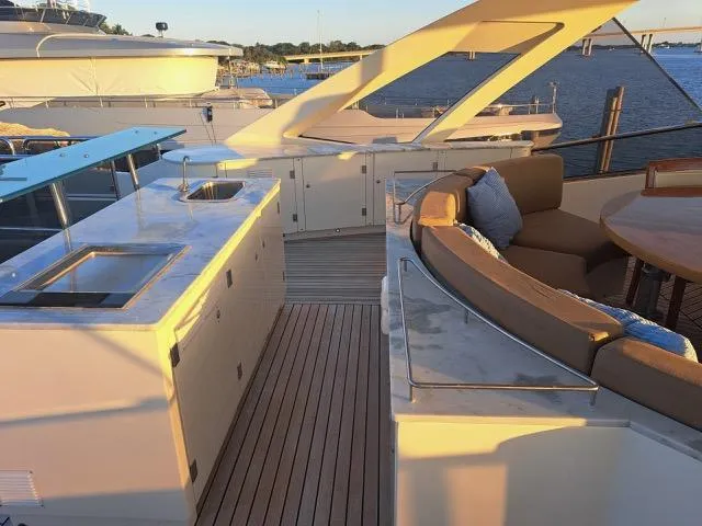 Slide: The Image of Luxurious 2009 Astondoa 95 GLX yacht deck with seating and kitchenette, overlooking serene waters. - 46