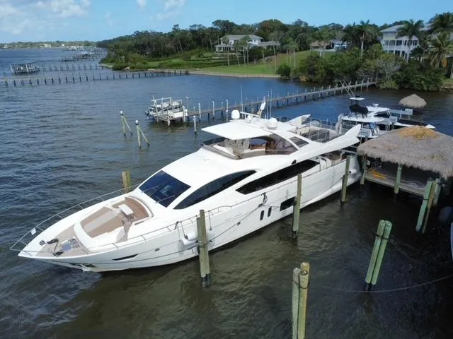 Slide: The Image of Astondoa 96 GLX 2009 yacht docked at a marina, surrounded by water and greenery. - 5