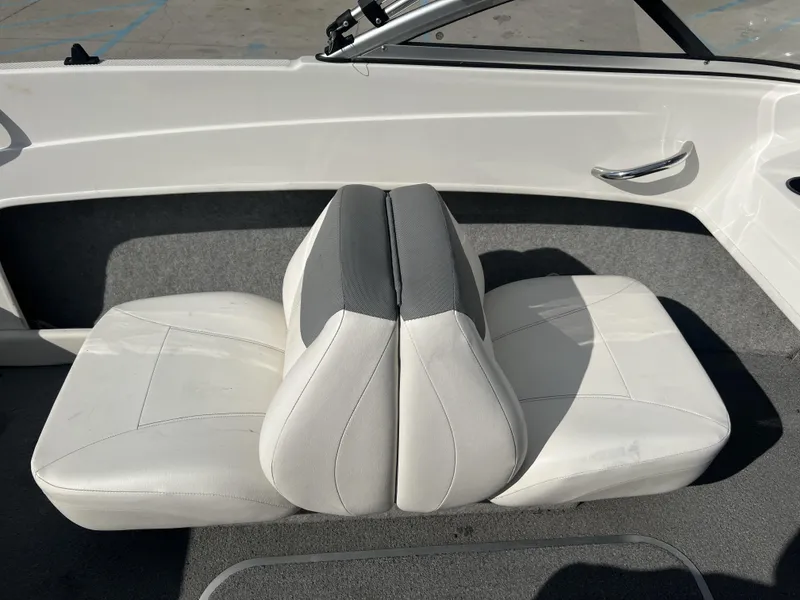 Slide: The Image of 2016 Bayliner 175 boat interior with white and gray seating. - 12