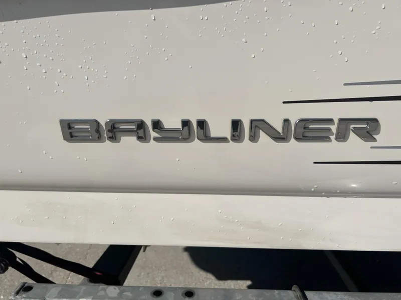 Slide: The Image of Bayliner 175 boat emblem, 2016 model, with water droplets on white surface. - 15