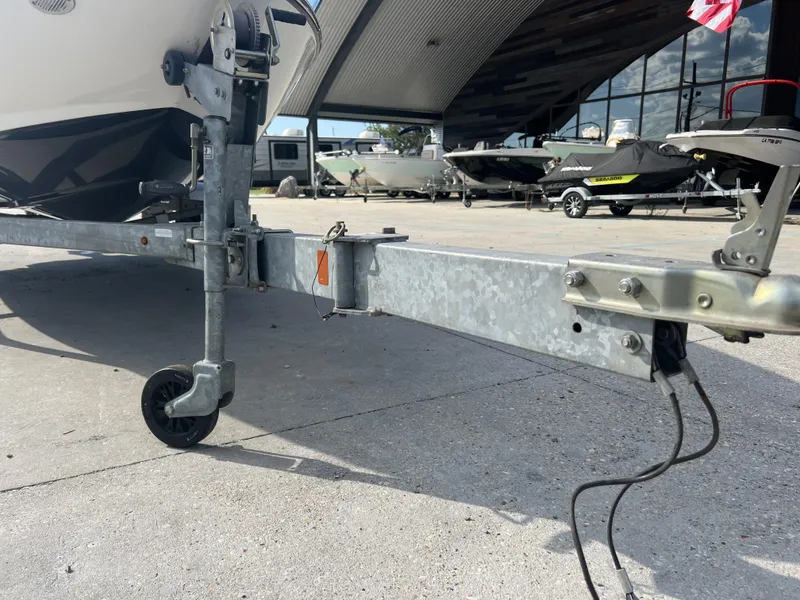 Slide: The Image of Trailer hitch of a 2016 Bayliner 175 boat in a marina setting. - 17