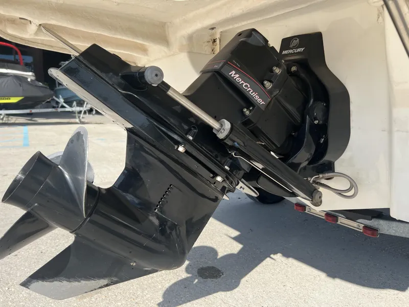 Slide: The Image of 2016 Bayliner 175 with MerCruiser engine and propeller, parked on concrete surface. - 4