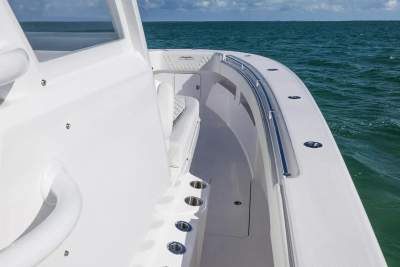 Slide: The Image of 2025 Invincible 36 Open Fisherman boat on ocean, showcasing sleek design and spacious deck. - 11