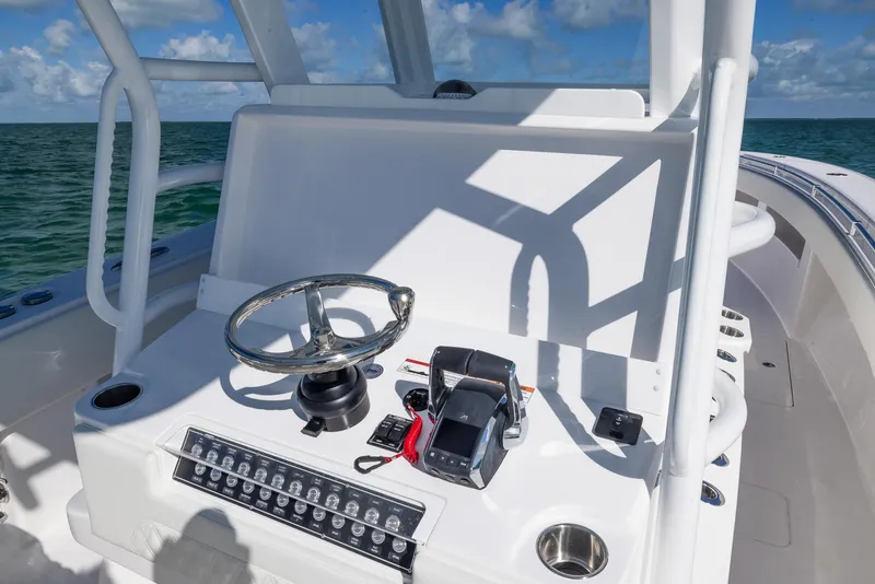 Slide: The Image of 2025 Invincible 36 Open Fisherman boat console with steering wheel and controls. - 13